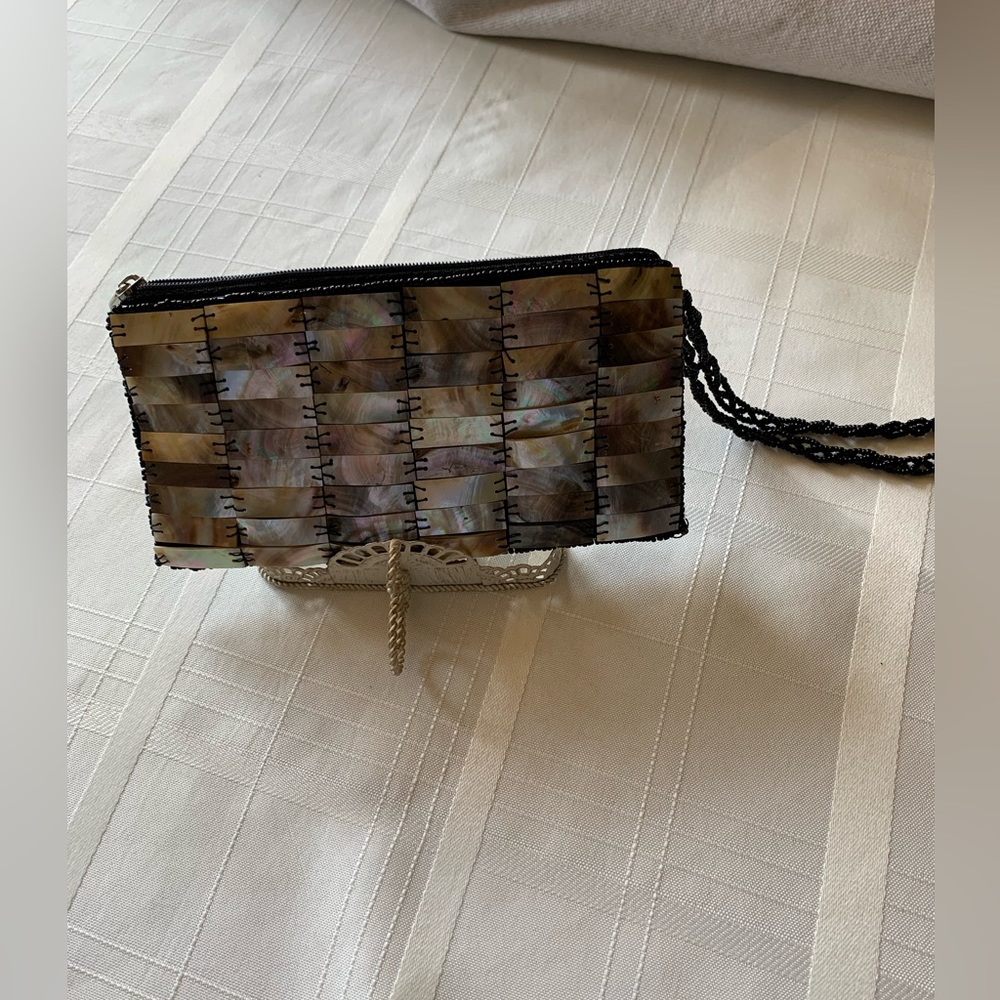 mod by design handmade in Vietnam. Natural spun silk and horn.